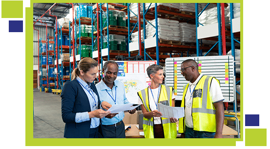 Front view of mature diverse staffs discussing over document in warehouse. This is a freight transportation and distribution warehouse. Industrial and industrial workers